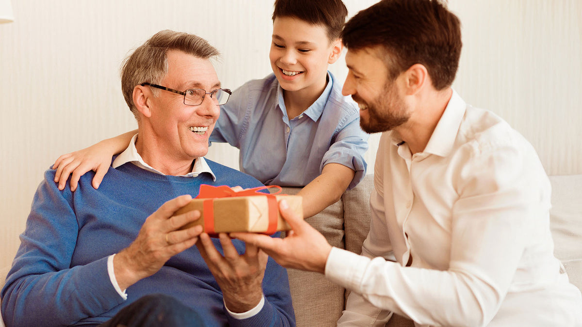 Dad and Son Giving Gifts to Grandpa