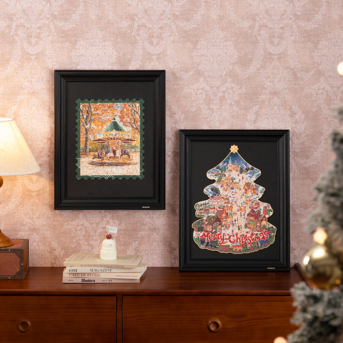 Two Rowood wooden puzzles framed and displayed on wall, Christmas Town tree shape and carousel puzzle in black frames