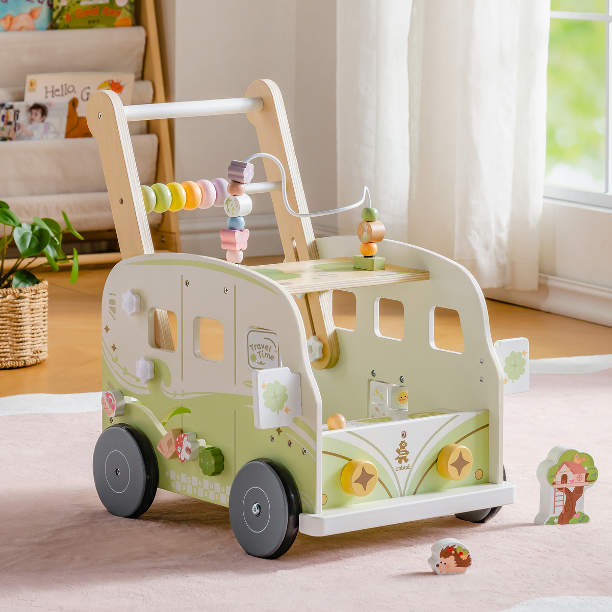 ROBUD green bus baby walker with rainbow abacus displayed in a sunlit room with bookshelf and natural wood tones.