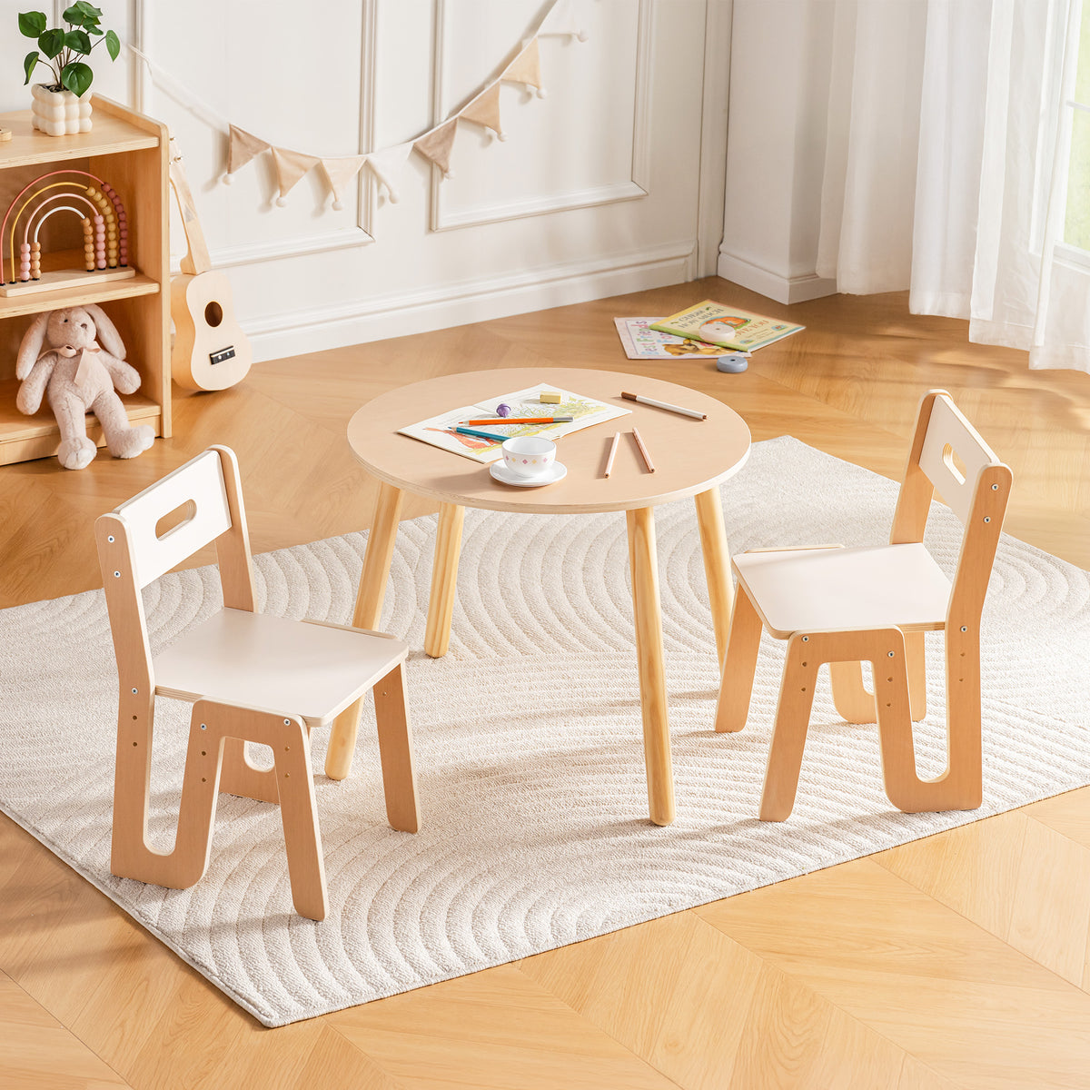 ROBUD Glowwood round natural wood table with two matching white-seat chairs on a hardwood floor playroom.