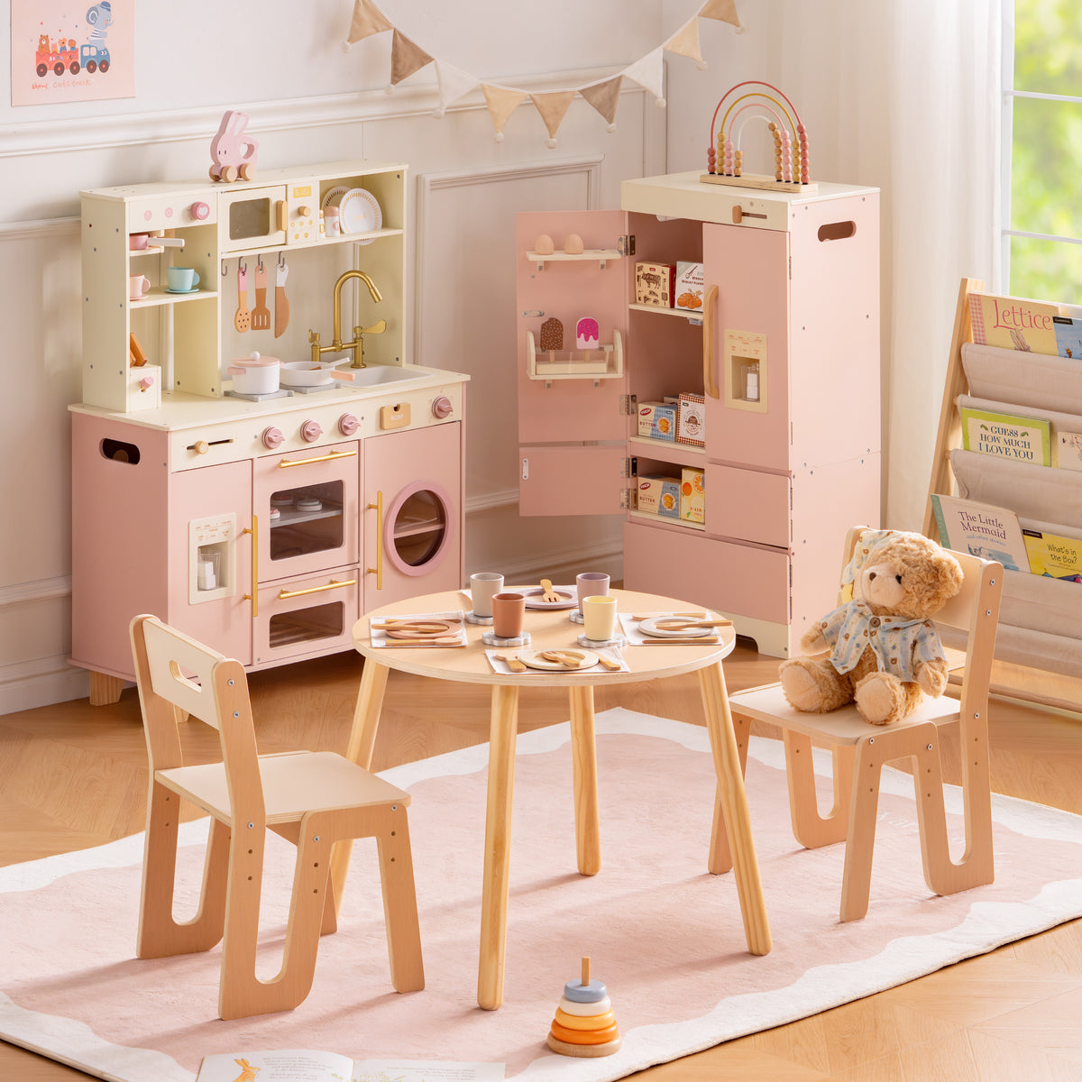 ROBUD Glowwood Kitchen House complete set with pink kitchen, refrigerator, table, and two chairs in a pink-toned playroom.