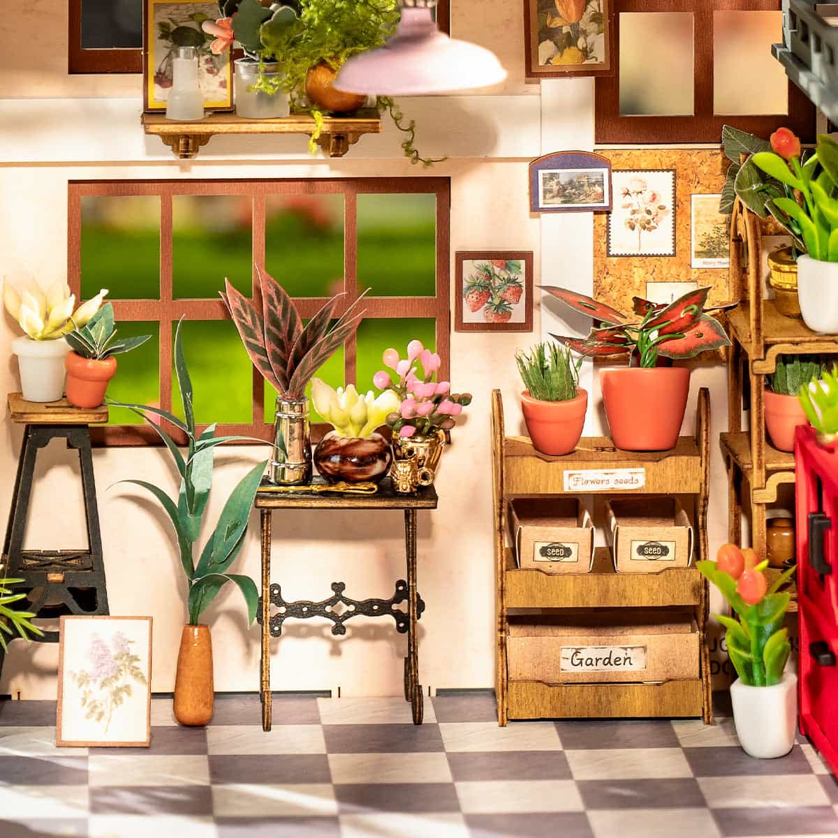 Rolife Emily's Flower Shop DG145 miniature house interior close-up of a worktable with gingham cloth, scissors, seed packets, potted tropical plants and a woven stool