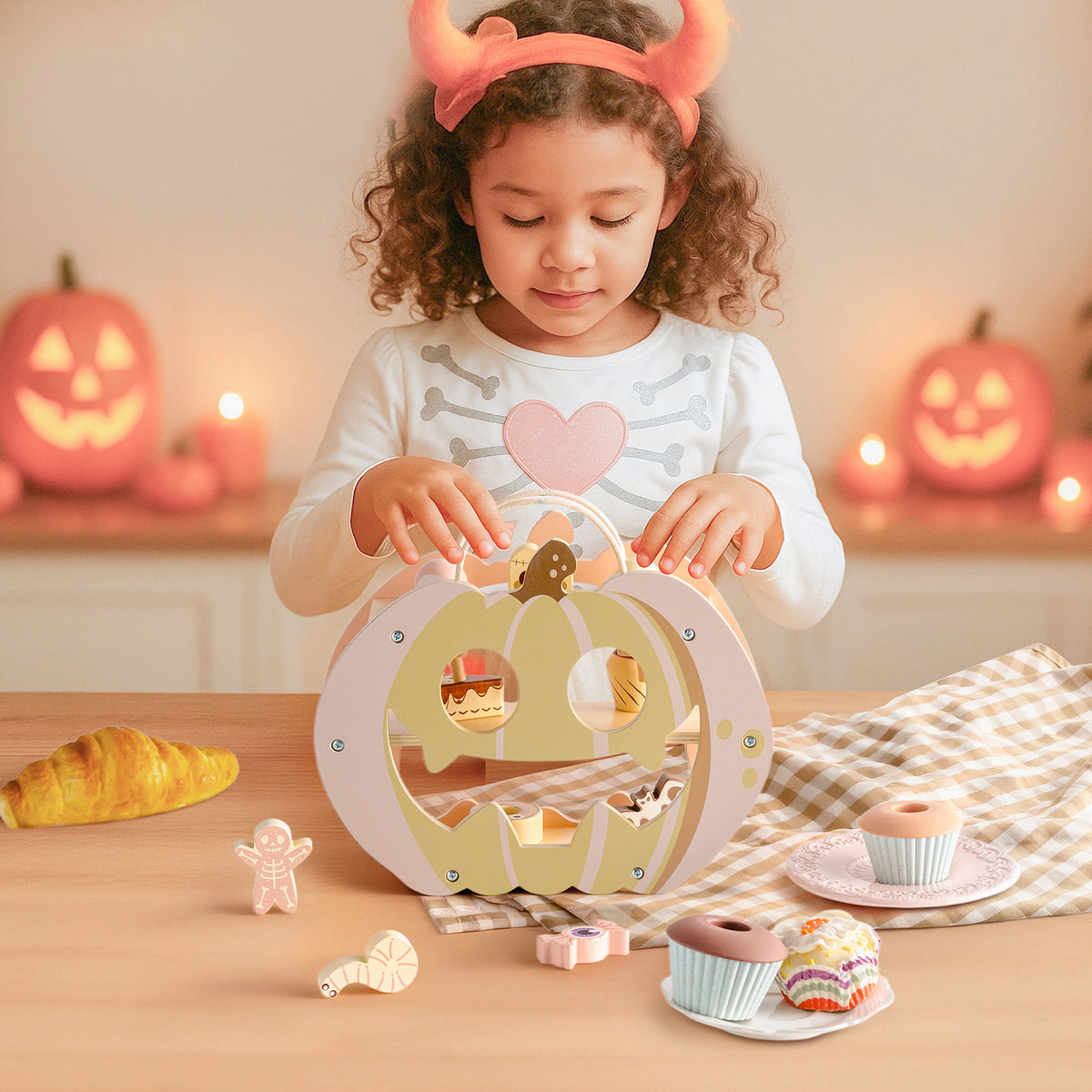 ROBUD Halloween Candy House wooden pumpkin display shelf styled with ghost figurines and pastel candy pieces on a table near a bright window
