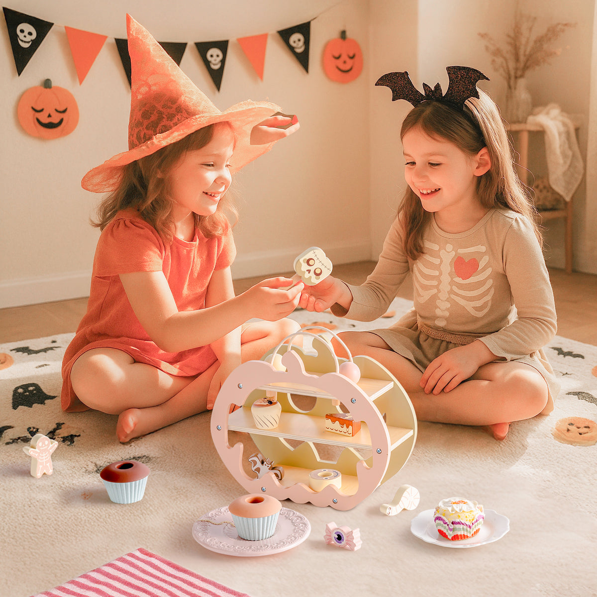 Girl in devil horns carefully placing cookies and sweets into ROBUD Halloween Candy House wooden pumpkin in a warmly lit room