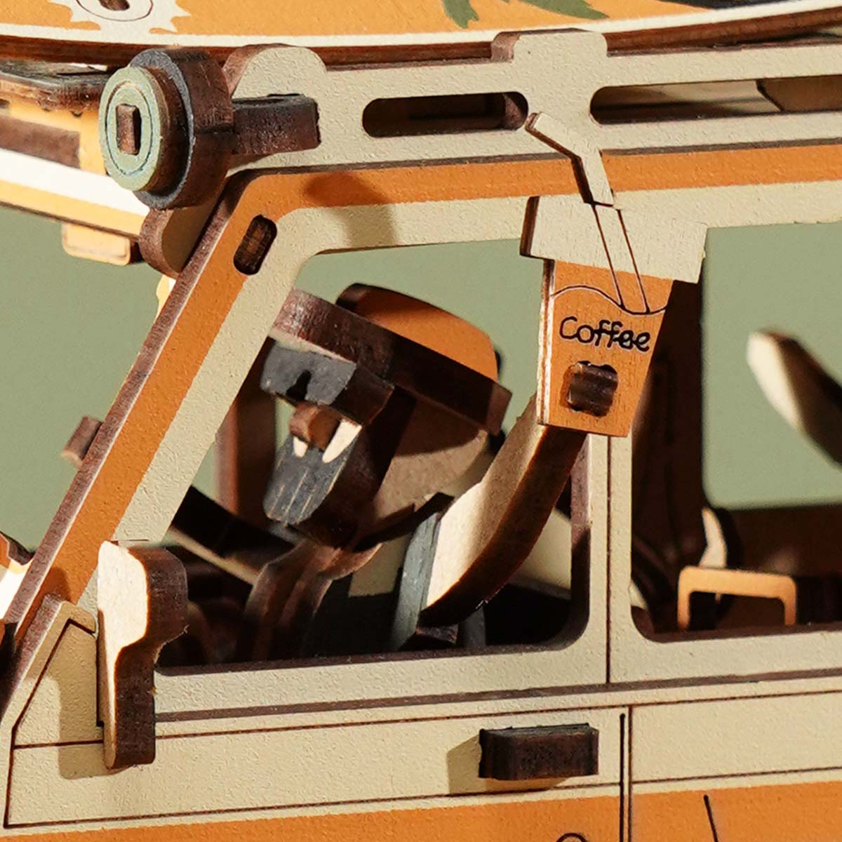 ROKR Road Tripper Gravity Swing MCD03 close-up of cabin interior detail showing driver figure, steering wheel, and orange-toned sun-filled dashboard through side window