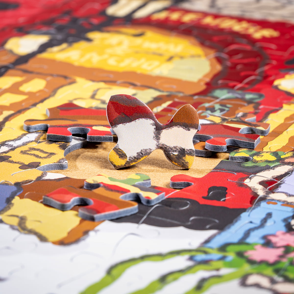 Close-up of Rolife Welcome to Covent Garden PT006 puzzle pieces scattered showing warm red and orange building tones