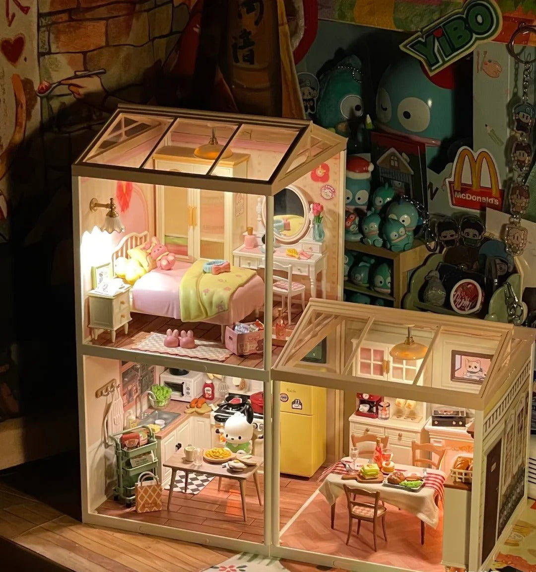 Rolife Super Creator miniature dollhouse photograph submitted by a customer showing multiple lit rooms embedded in a white wardrobe gap in a real home kitchen