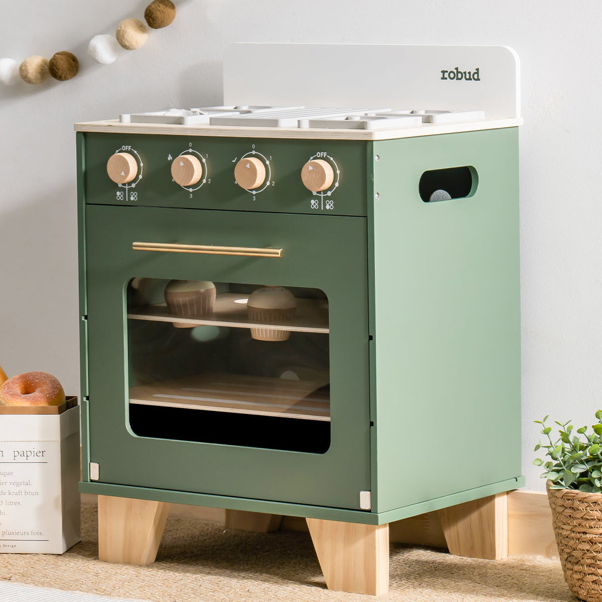 ROBUD wooden kitchen oven toy with side storage drawer and cream white upper panel and controls.
