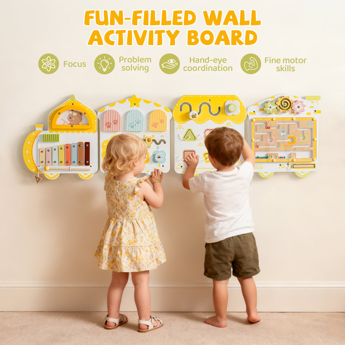 Two toddlers stand at the ROBUD yellow spring train busy board mounted on a white wall, playing side by side with the panels.