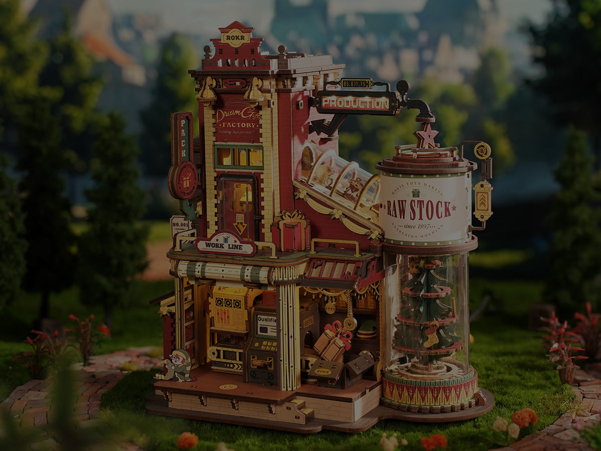 Rolife Leisure Time Tea Room miniature dollhouse lit up from inside showing a vibrant blue shopfront with cakes, teaware and an outdoor table