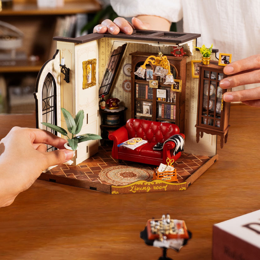 Three Rolife book nook and miniature models including Shakespeare book nook and Japanese alley scene on red background.