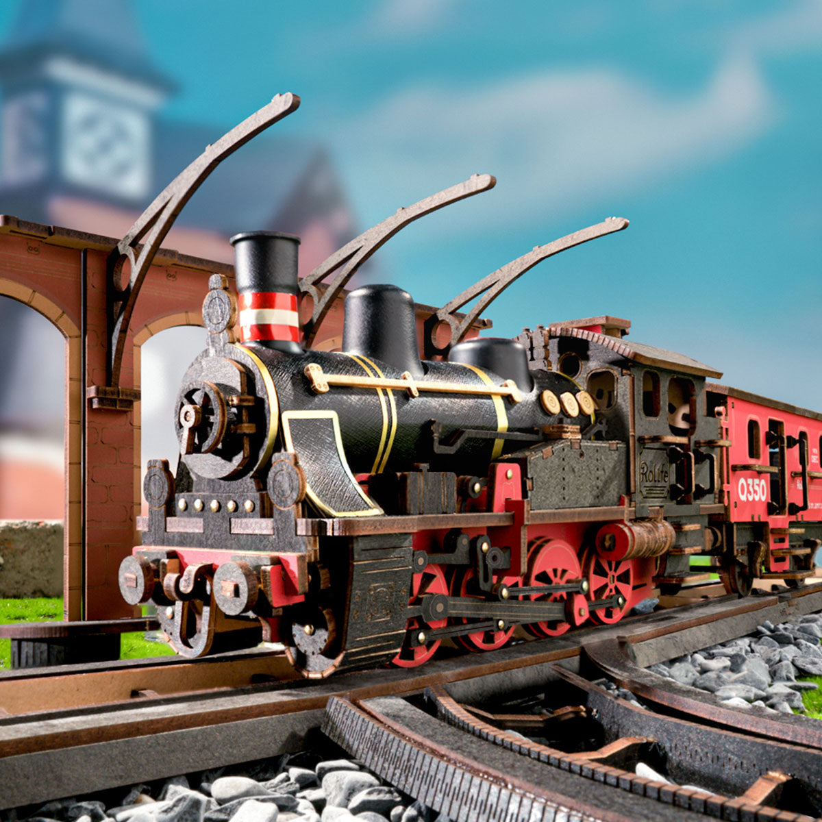 Rolife Steam Journey locomotive rides on curved track under a bright blue sky.