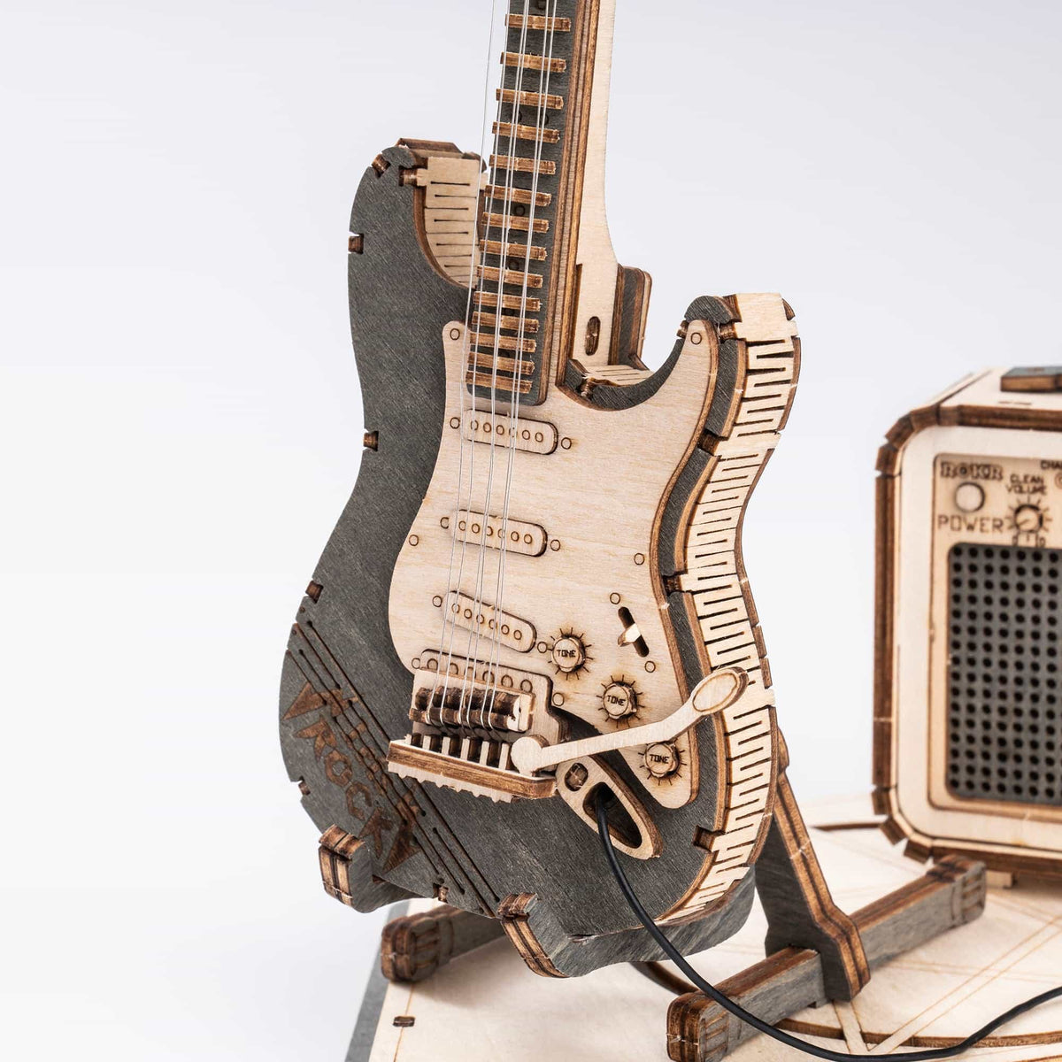 Close-up front view of ROKR wooden electric guitar model body with laser-etched pickup and bridge details