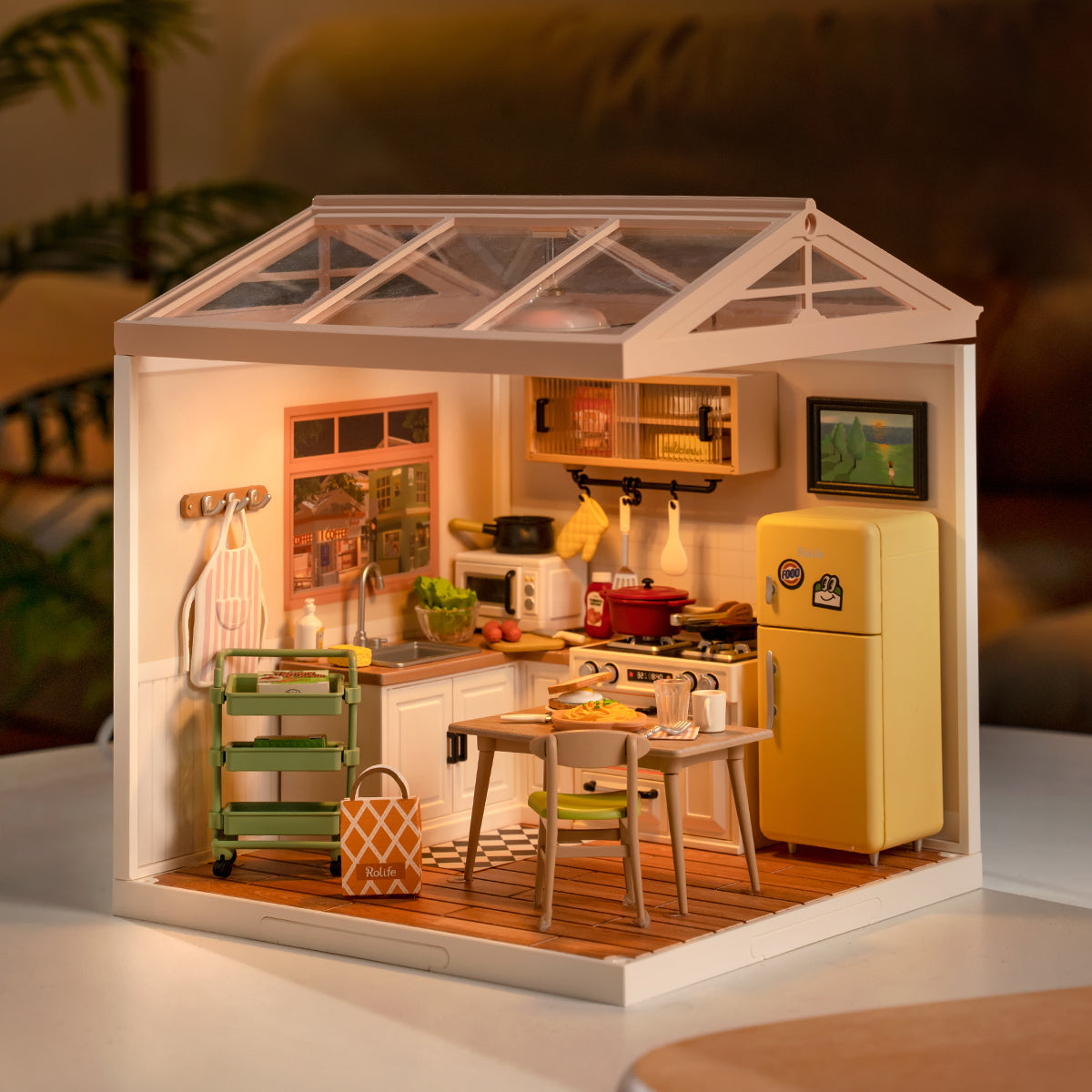 Rolife Happy Meals Kitchen DW008 miniature house DIY kit showing a warm yellow kitchen interior with tiny cooking