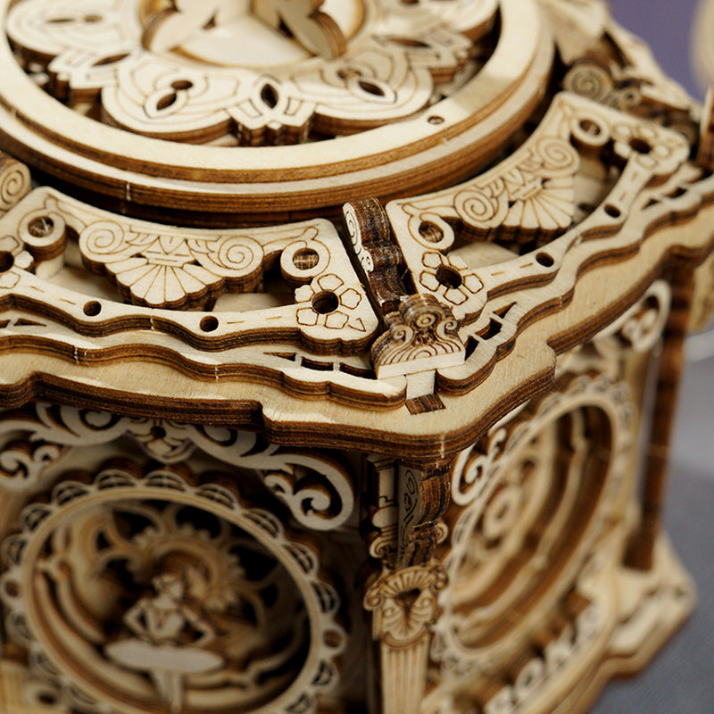 ROKR Secret Garden music box angled view showing intricate carved floral relief panels on natural walnut wood sides