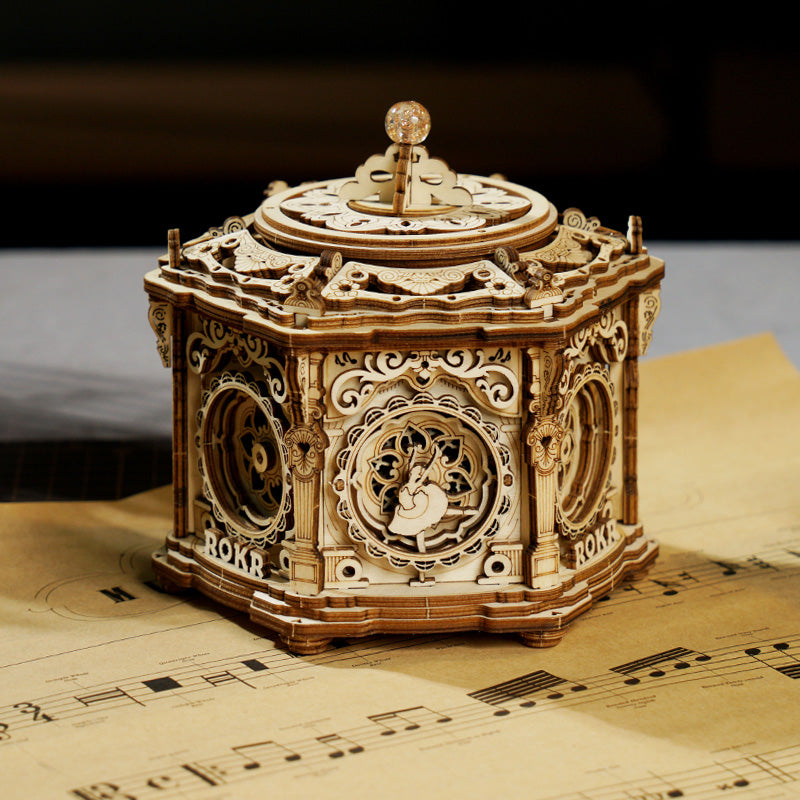 ROKR Secret Garden hexagonal mechanical music box in warm walnut wood with decorative floral panels on sheet music