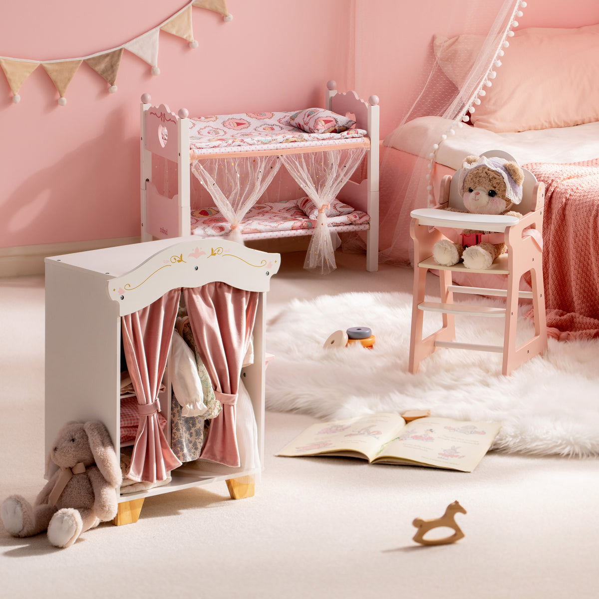 ROBUD pink doll wardrobe with curtains shown in a cosy girls bedroom alongside a bunk bed and high chair.