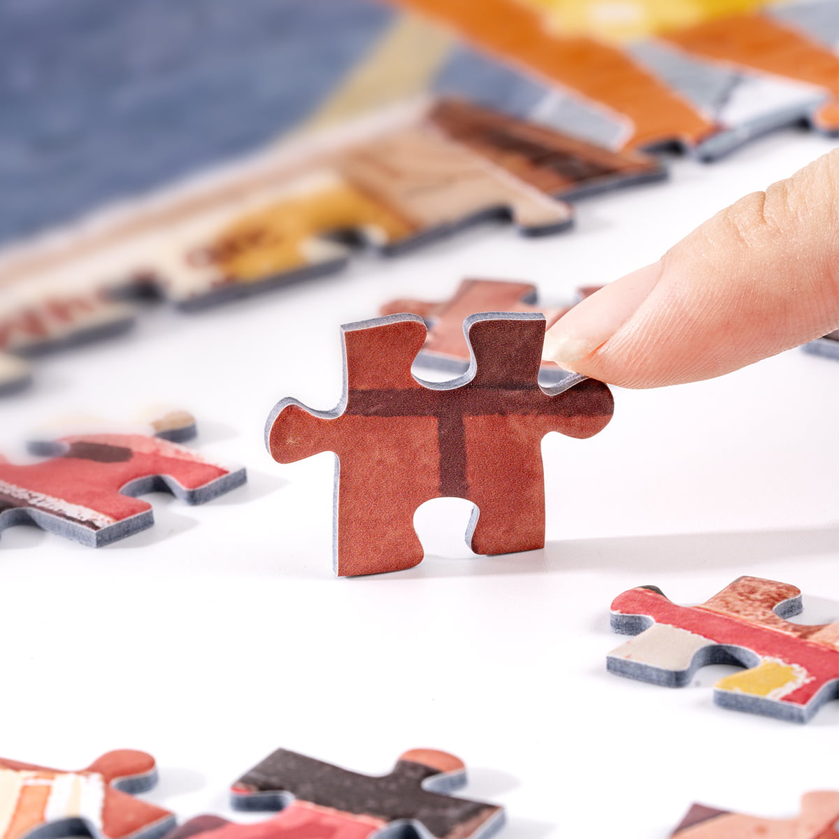Close-up of a single Rolife Walk in London PT003 puzzle piece being placed showing red bus and street detail texture