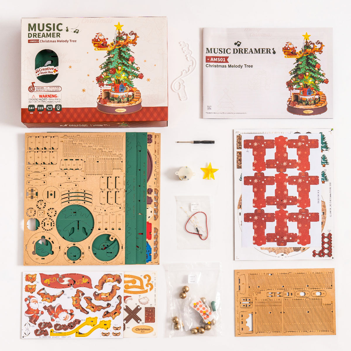 Rolife Christmas Melody Tree AMS01 flat-lay kit contents showing laser-cut wooden sheets, star topper, music mechanism, and decorative stickers