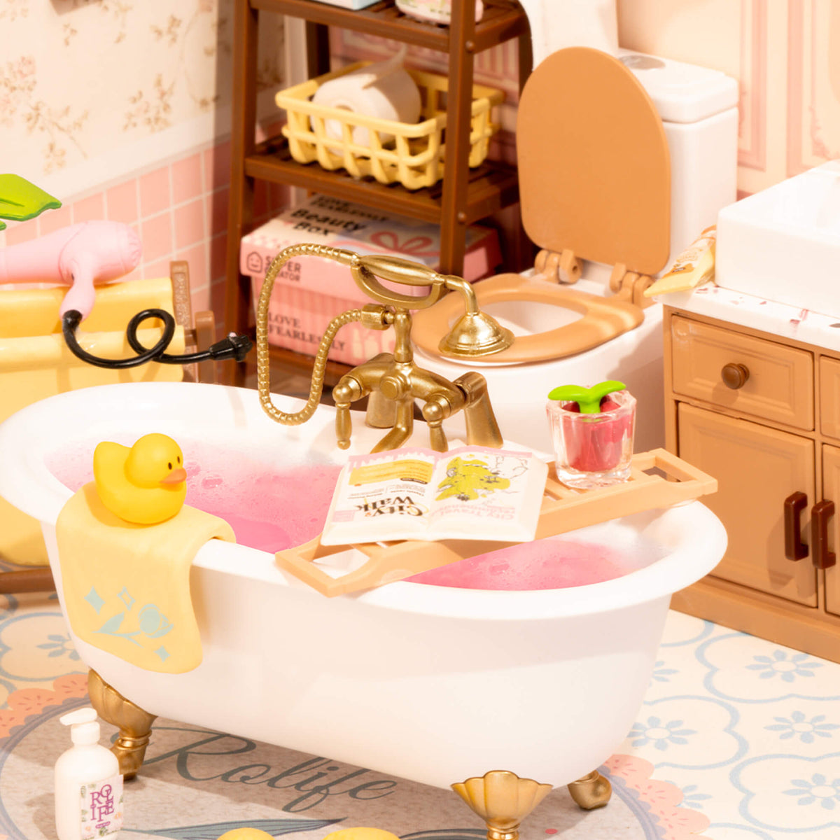 Rolife Pop Bubble Bathroom miniature glowing with warm LED light in a pink dreamy setting, showing the full bathtub scene with decorative details.
