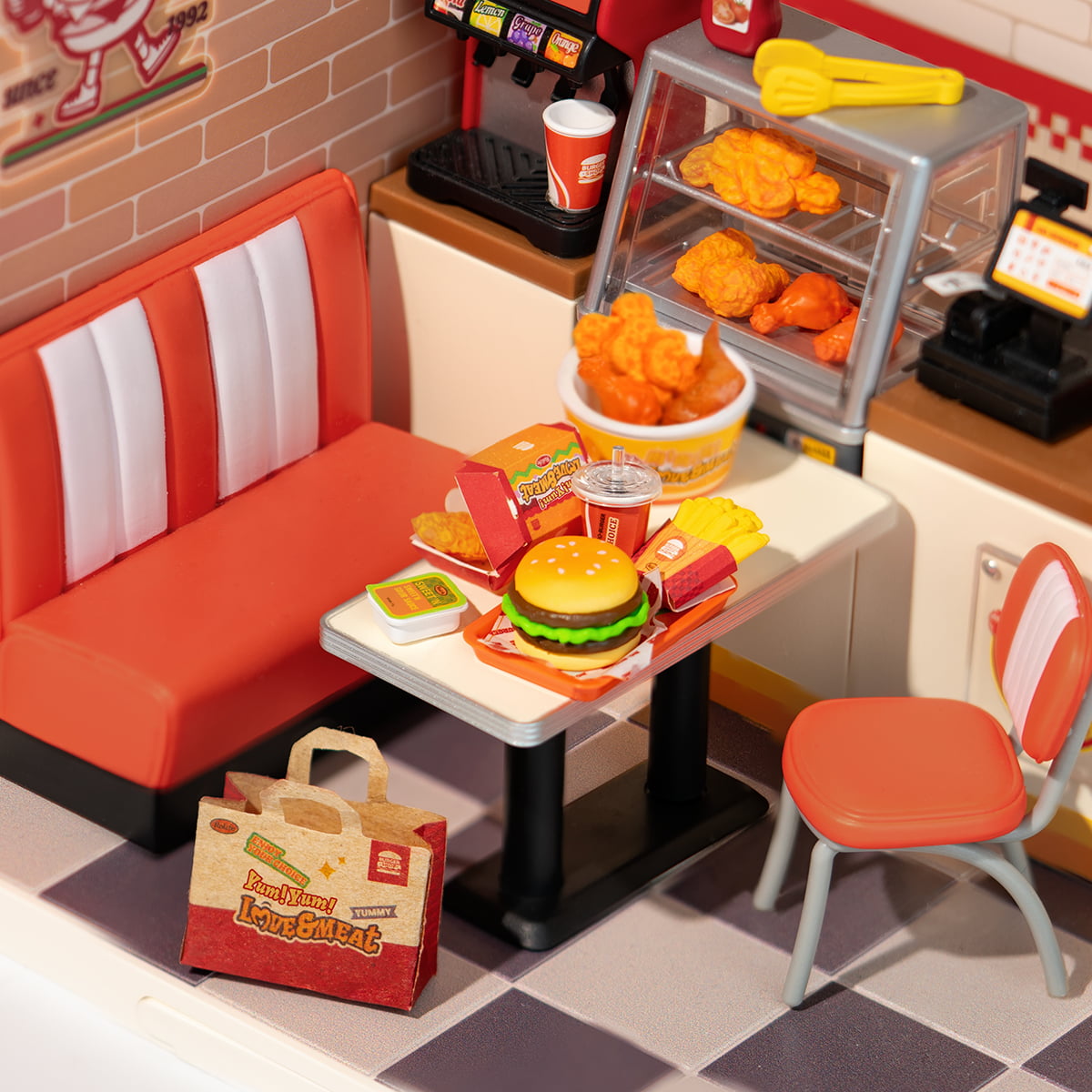 Rolife Yum Yum Burgers DW010 close up of the retro diner seating area showing a burger meal on tray beside the checkered red and white booth
