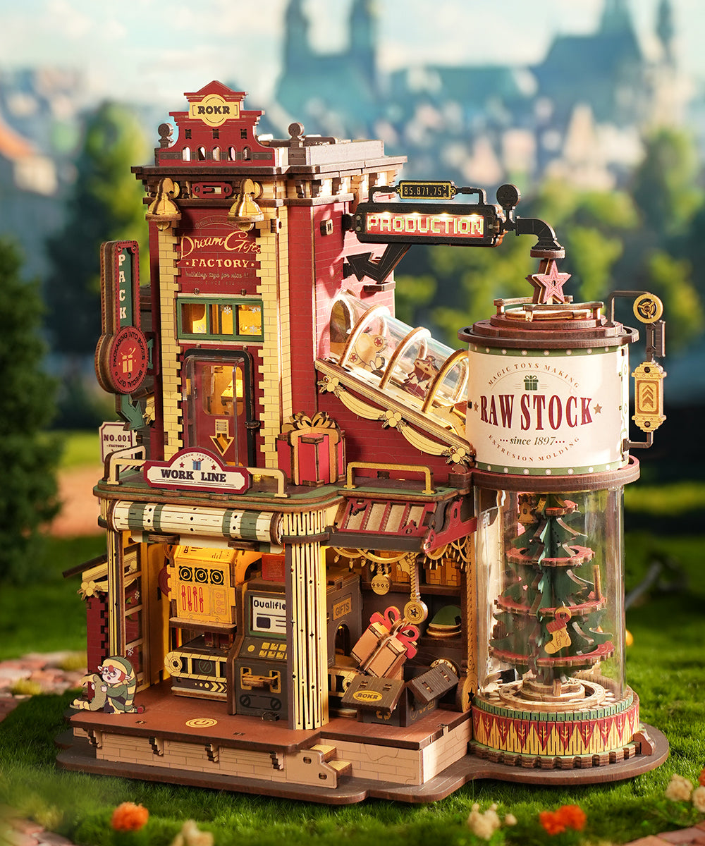 ROKR Dream Gift Factory wooden music box EAB01 fully assembled red Victorian-style building with working production line conveyor and Christmas tree display on a grassy base