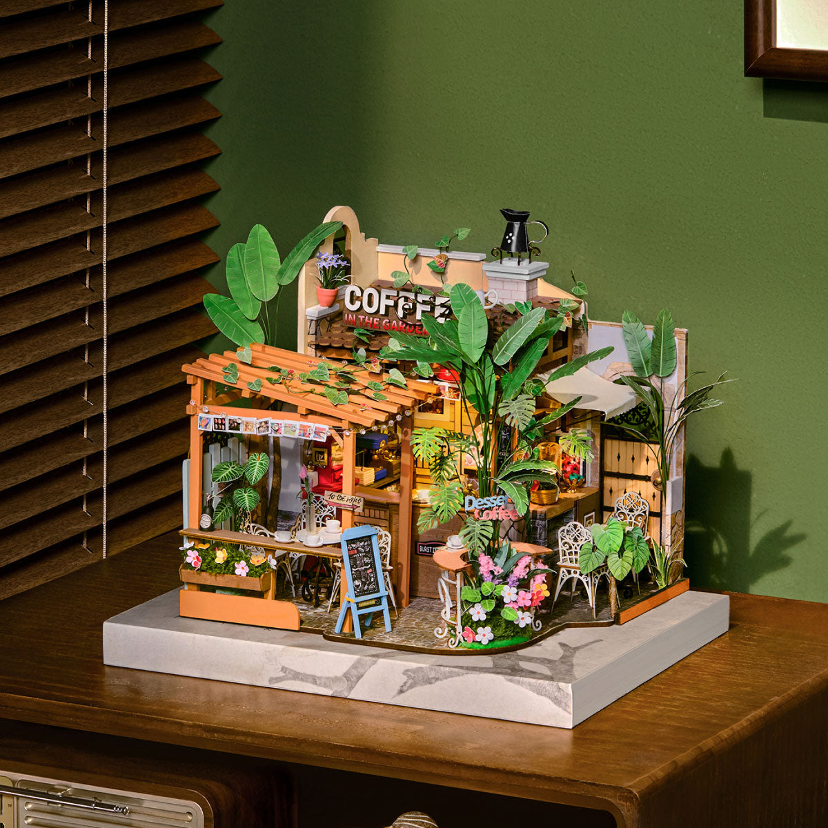 Completed Leafree Cafe displayed on a wooden cabinet against a deep green wall