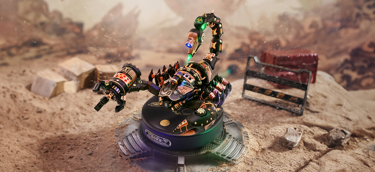 ROKR Emperor Scorpion mechanical 3D wooden puzzle MI04 rendered in dark metallic finish with glowing green LED stinger poised on a rocky desert terrain diorama