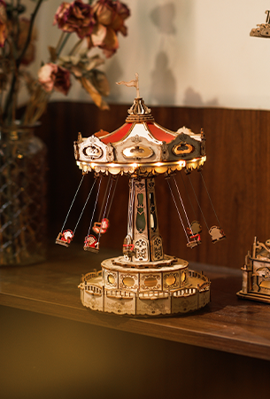 Robotime Music interest category tile, Rolife swing carousel music box on a wooden shelf with warm amber lighting and bokeh background
