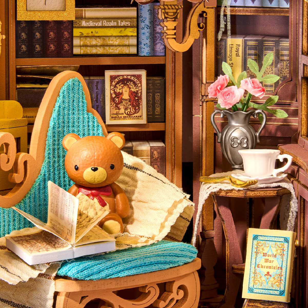 Interior detail of Rolife Quiet Corner Study showing a teddy bear seated in a teal armchair with pink roses and bookshelves