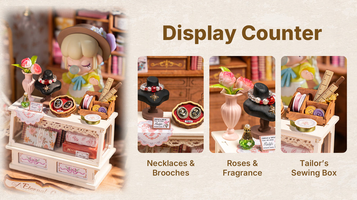 Rolife Elsa's Tailoring DG178 miniature house display counter detail showing necklace stand, brooch tray, roses and tailor sewing box with text labels