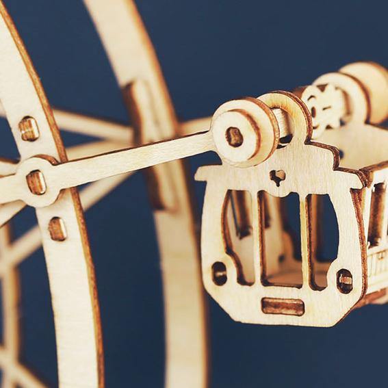Rolife Ferris Wheel TGN01 close-up showing gondola car and wooden spoke detail against deep navy blue background