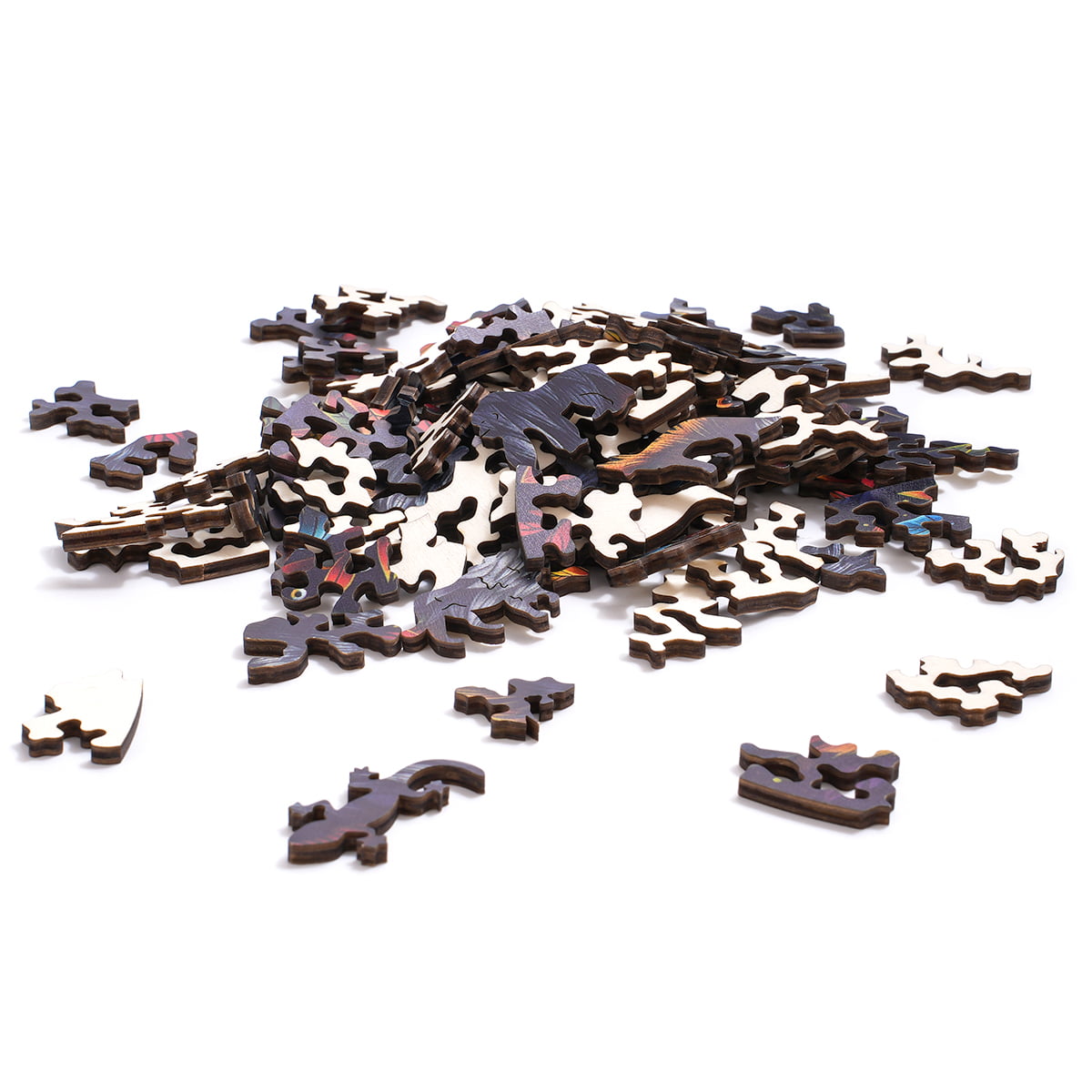 Loose wooden pieces from the Robotime Wolf in the Jungle puzzle spread on a white surface, showing the dark-stained irregular animal silhouette shapes before assembly