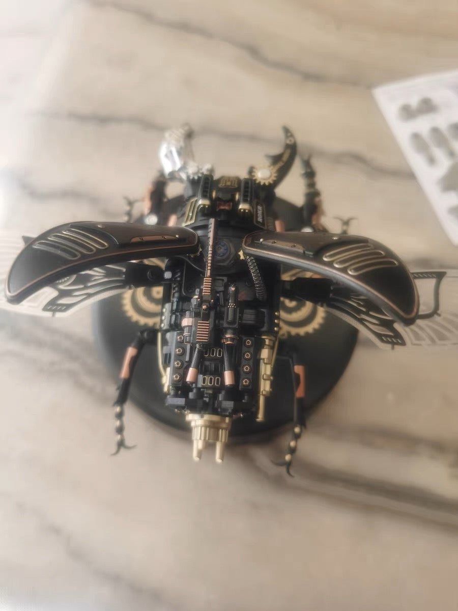ROKR mechanical stag beetle model in black with exposed gear mechanisms resting on a marble surface