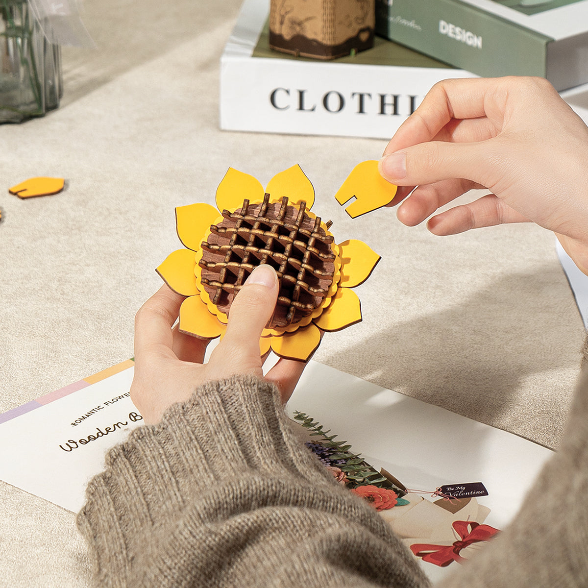 Rowood wooden sunflower puzzle is assembled by hand with yellow petals around a brown center.