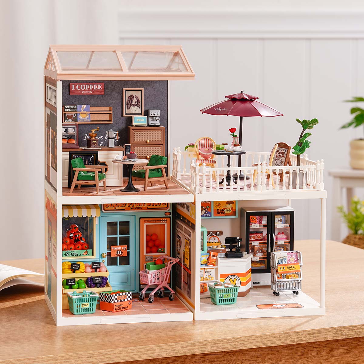 Rolife Super Creator Series 3-in-1 L Shape wide horizontal miniature with six furnished rooms including bedroom, garden tea room, kitchen, living room, dining room, and clawfoot bath on a table.
