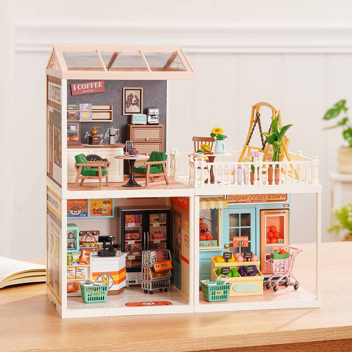 Rolife Super Creator Series 3-in-1 L Shape miniature with a coffee shop module on top and a supermarket checkout counter plus fruit store across the lower level on a wooden surface.