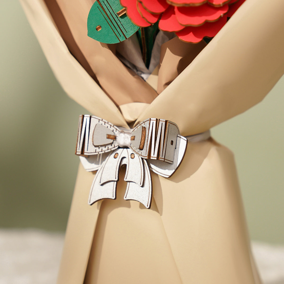 Rowood bouquet close detail shows cream wrapping, ribbon, and layered wooden flower stems.