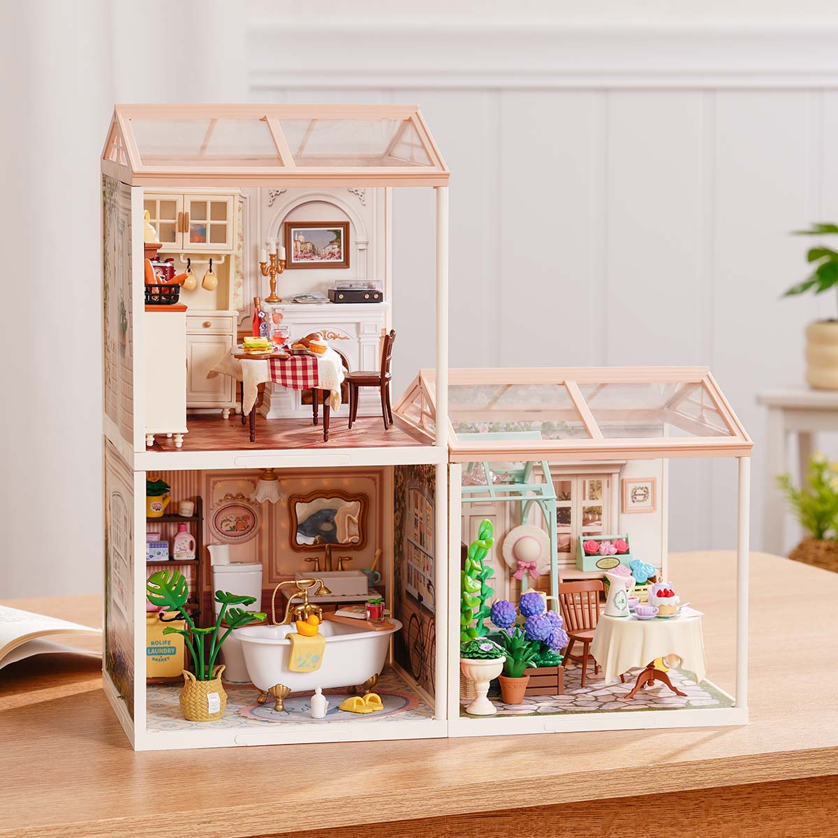 Rolife Super Creator Series 3-in-1 L Shape miniature combining a tall bakery module on the left and a two-room bookstore and bubble tea shop in an L frame on a desk.