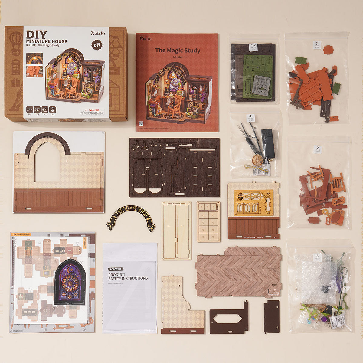 Rolife The Magic Study DG166 DIY miniature house flat lay showing retail box, wooden parts sheets and accessory bags