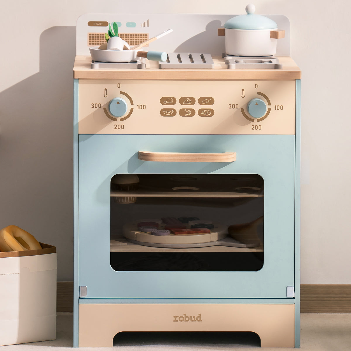 Robud wooden play oven with gas burner cooktop, close-up showing knobs and stovetop with teapot