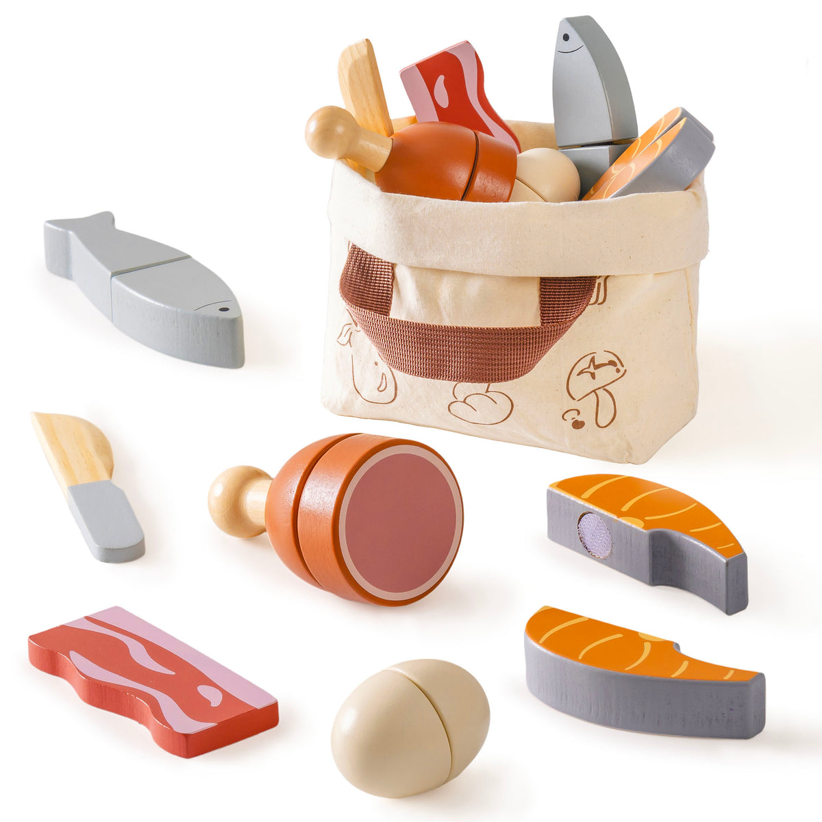 ROBUD wooden meat cutting playset flat lay showing grey herring fish halves, wooden knife, orange salmon steak, circular chicken leg, red bacon, cream egg, and canvas bag