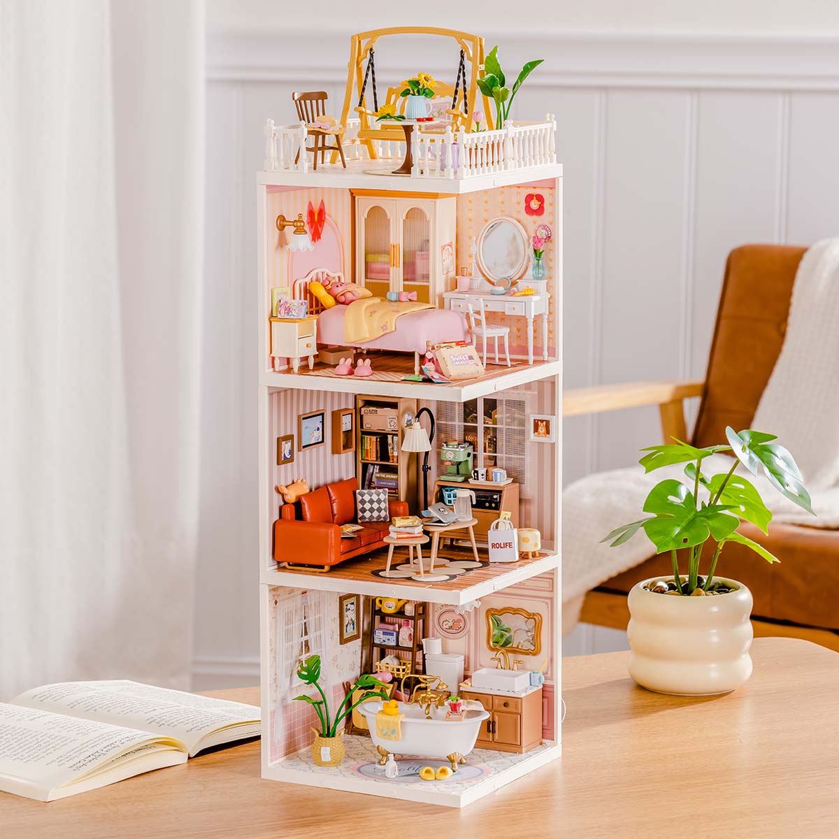 Rolife Super Creator Series 3-in-1 I Shape four-level miniature with rooftop umbrella terrace, bedroom, bookshelf living room, and yellow kitchen module on a wooden surface.