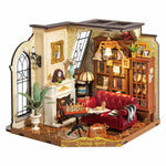 Rolife Catherine's Living Room DG175 DIY miniature house lit lifestyle shot on wooden table showing warm amber interior through the open front of the room box