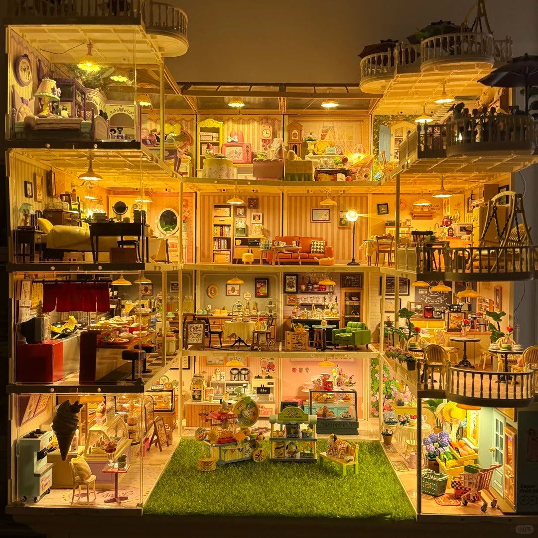 Illuminated Rolife multi-story dollhouse model glowing with warm light across four detailed floors including kitchen and living areas.