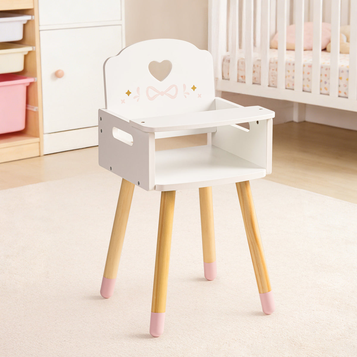 ROBUD white wooden doll high chair with heart-shaped backrest and pink-dipped legs displayed in a pink nursery room.