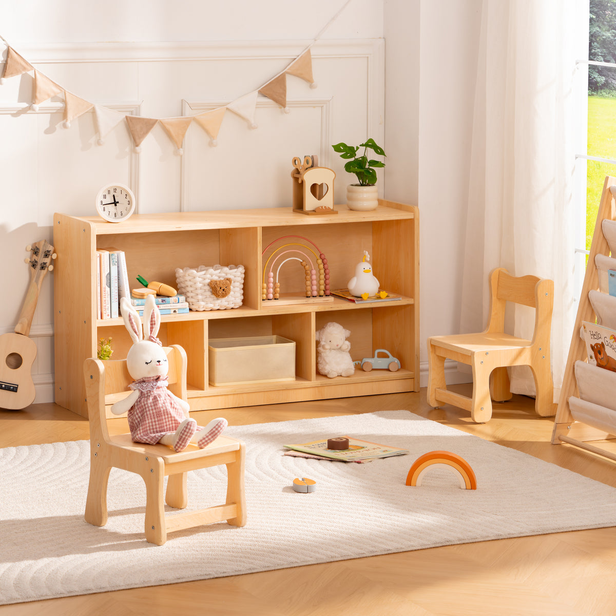 ROBUD natural wood bookshelf and matching chairs in a warm Scandi playroom beside a dinosaur chalkboard easel.