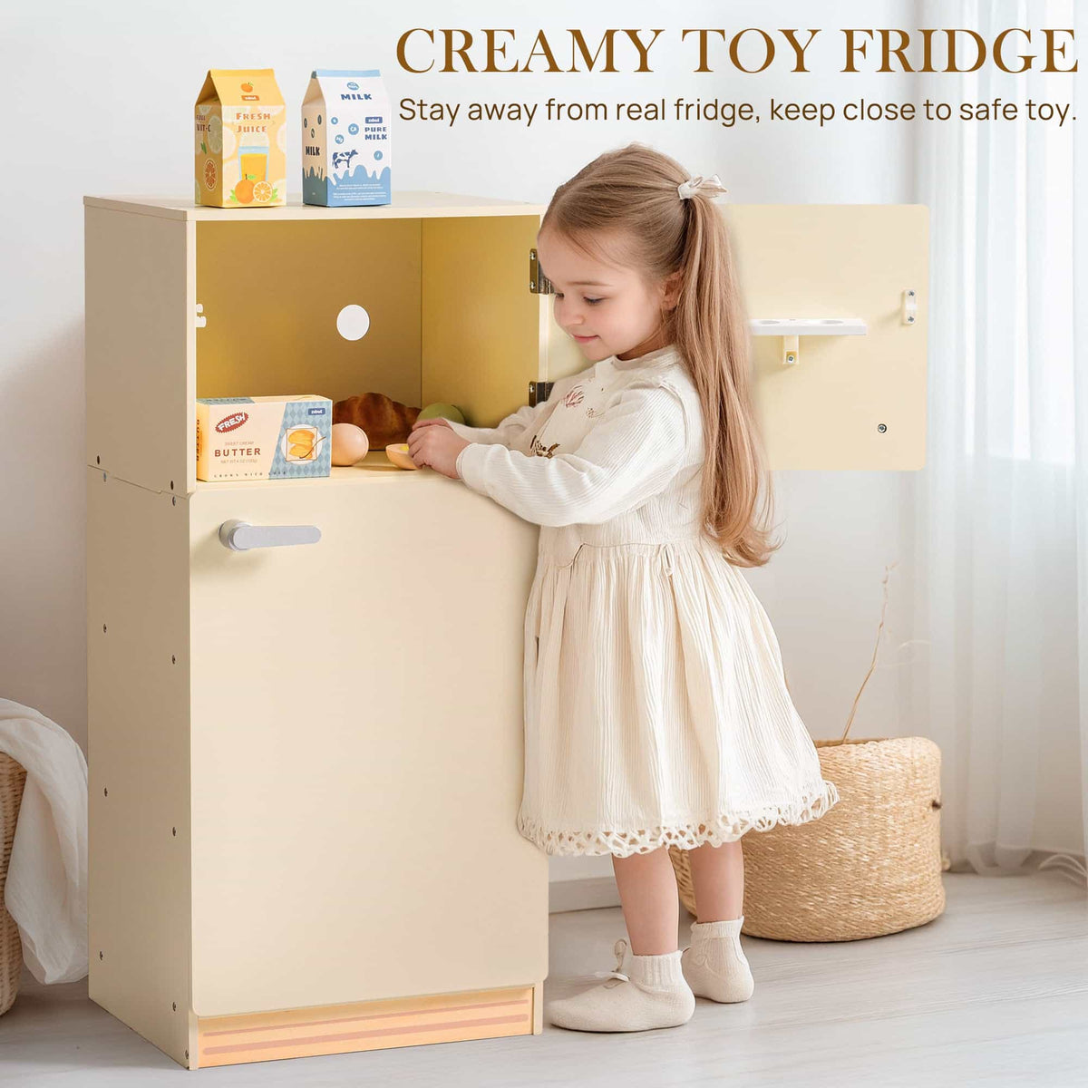 Young girl opening the upper door of the ROBUD creamy wooden play fridge filled with butter, croissant, and fruit pieces on yellow-lined interior shelves