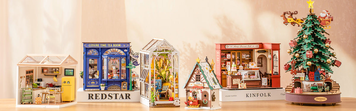 Rolife miniature dollhouse collection banner showing five completed models including tea room, greenhouse book nook, cabin, dessert shop, and Christmas tree music box on a shelf