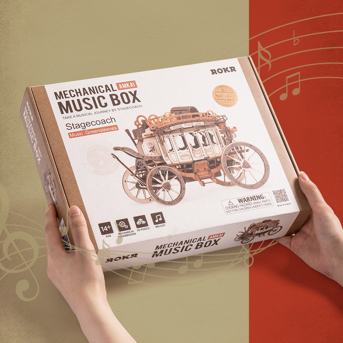 ROKR Stagecoach Music Box retail packaging held in two hands, tan cardboard box with red side panel